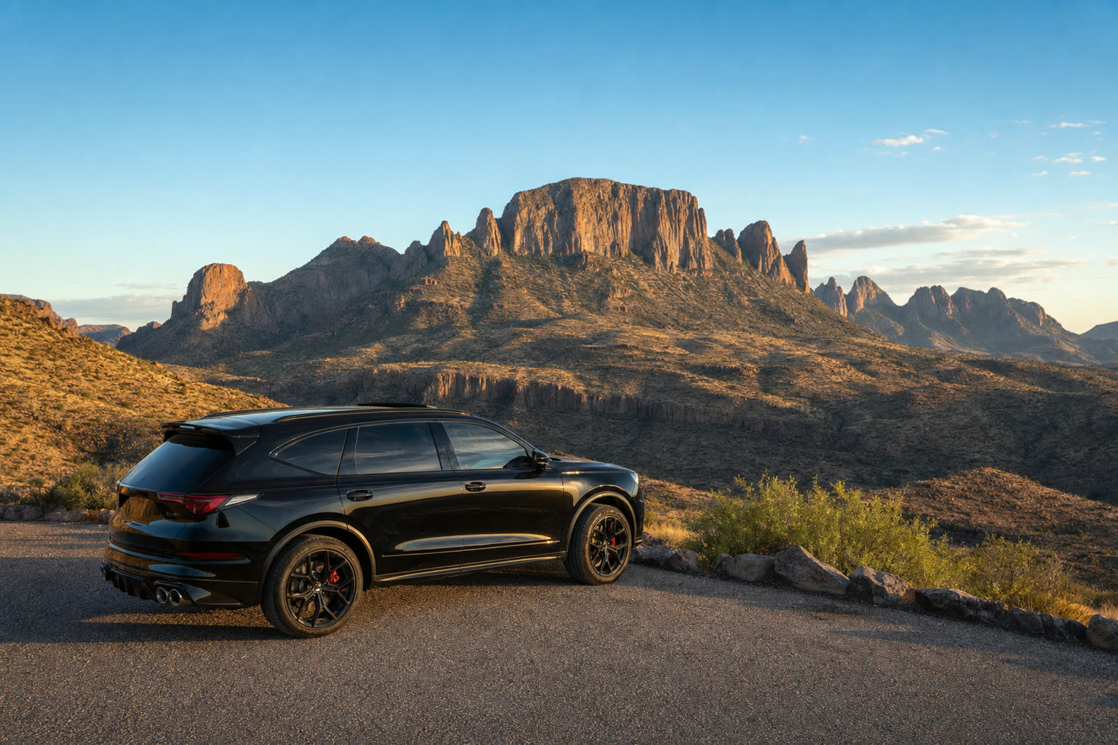 Black luxury SUV overlooking the Chisos Mountains in Big Bend National Park, West Texas